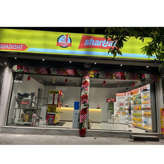 Illuminated ShareChat snack shop with floral decoration, shelves stocked with packaged snacks and drinks